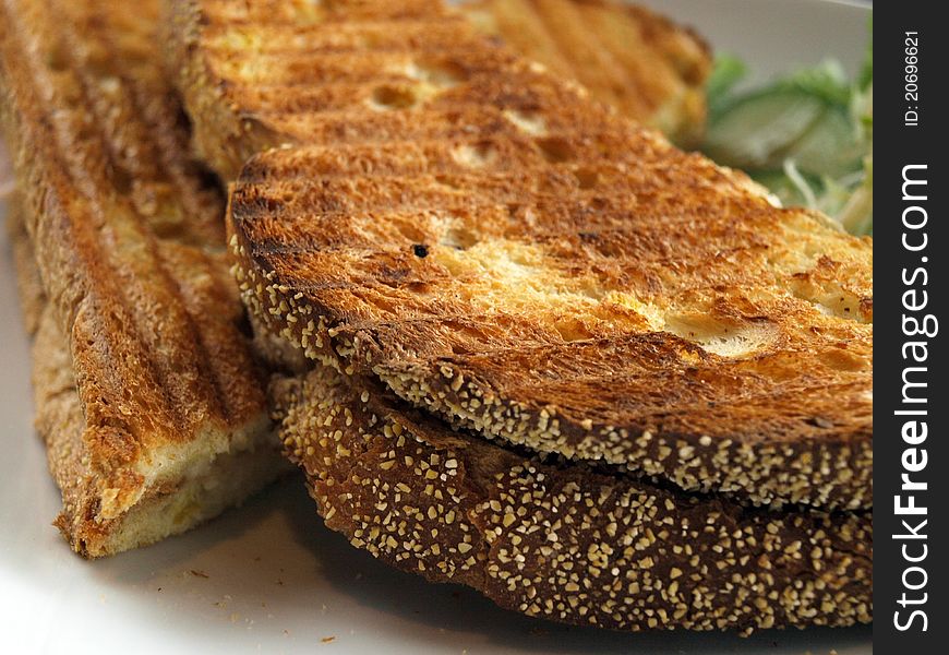 Toasted bread on a table served with salad close up