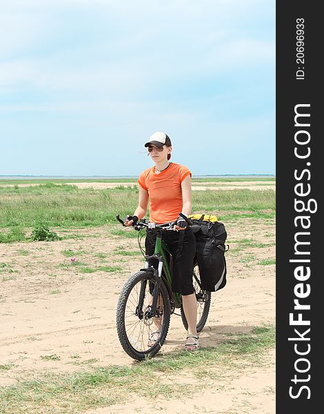 Bicycle tourist girl standing on road