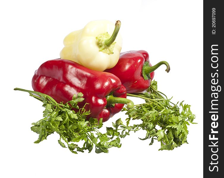 Fresh paprika decorated with parsley isolated on white