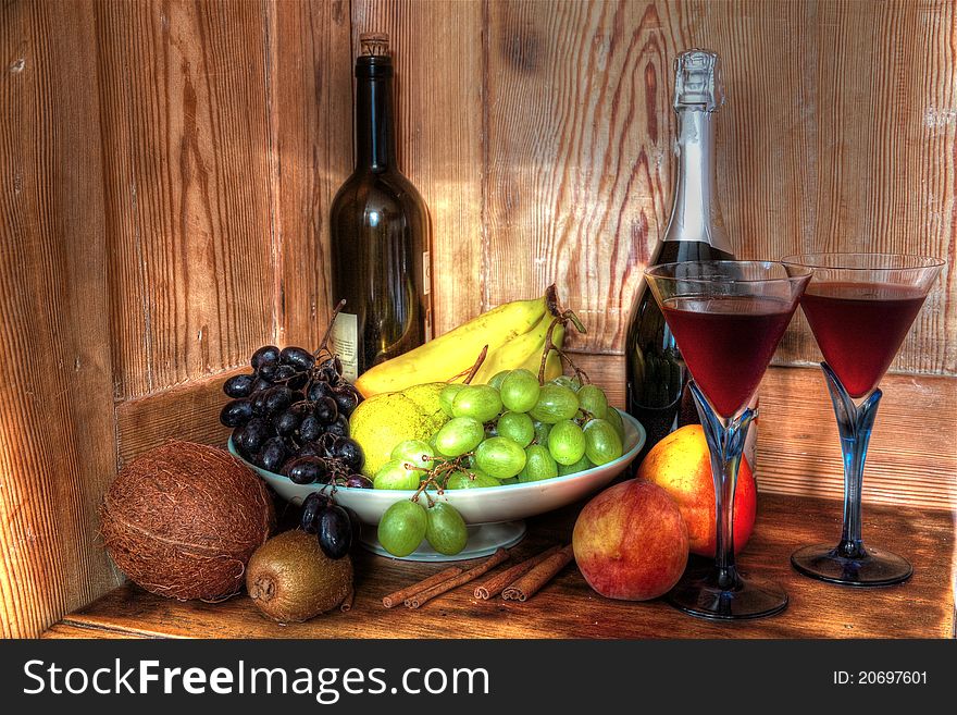 Red wine in glasses and fruits.