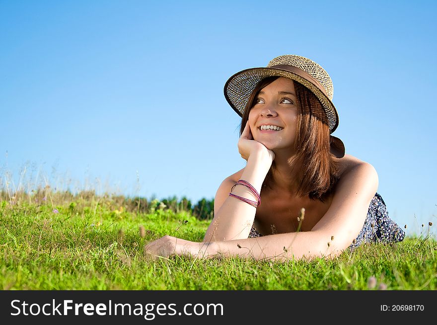 Smiling beautiful woman laying on grass
