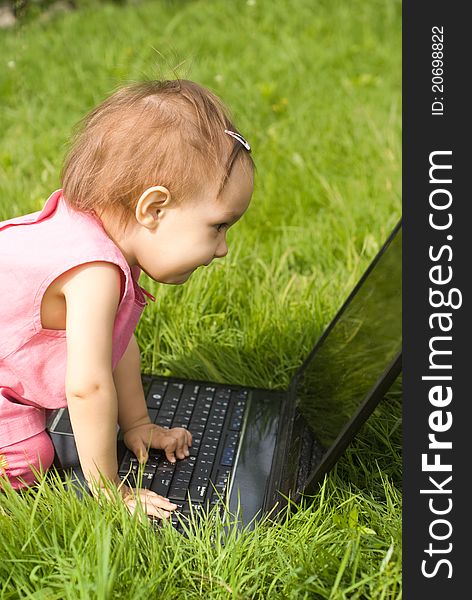 Little girl with a laptop at nature. Little girl with a laptop at nature