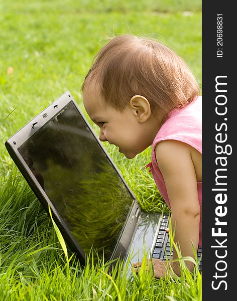 Little girl with a laptop at nature. Little girl with a laptop at nature