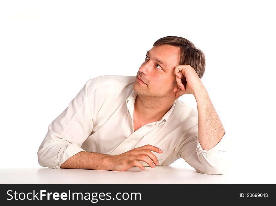 Cute adult man sitting at table on white. Cute adult man sitting at table on white