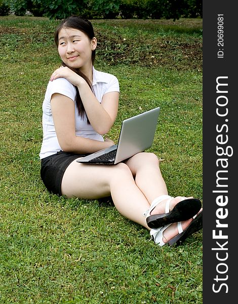 Girl working on laptop outdoor