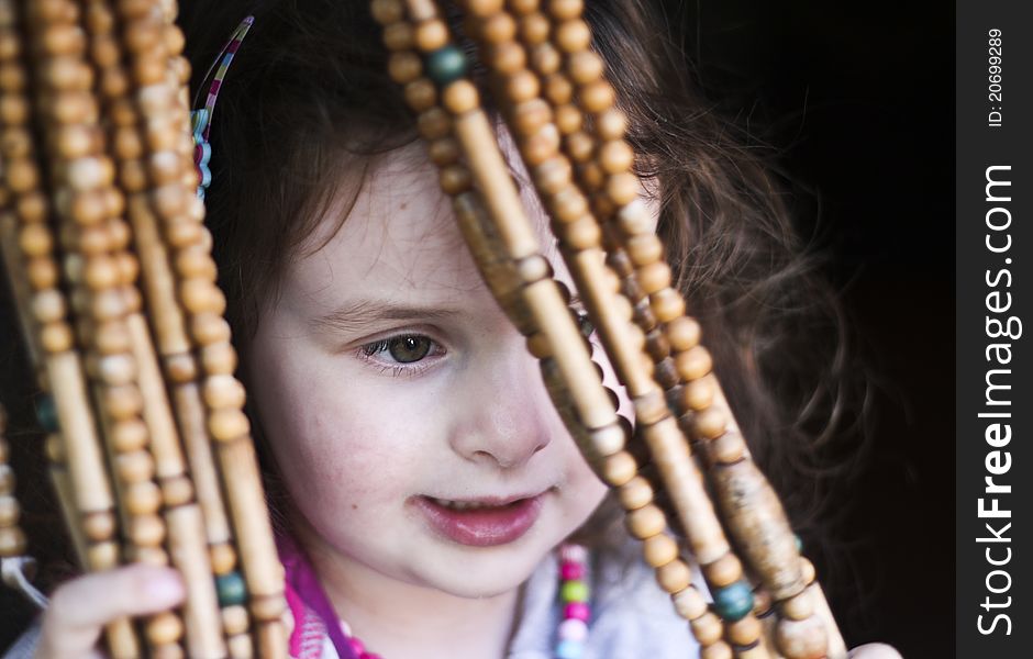 Surprised Little Girl Behind The Coral Curtain