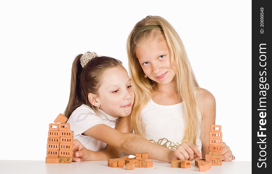 Portrait of a two little sisters at table. Portrait of a two little sisters at table