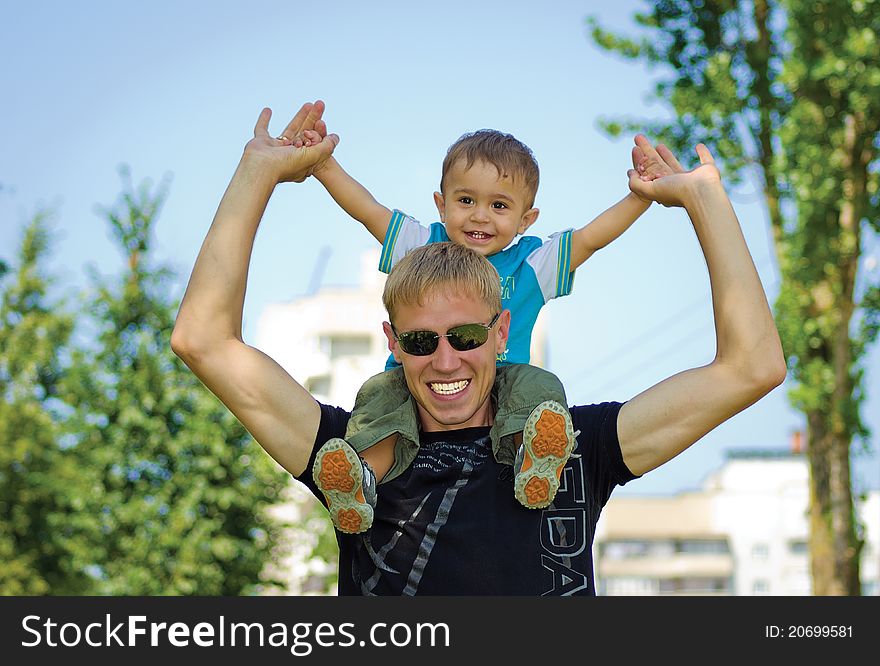 Dad with his son walking in a park. Dad with his son walking in a park