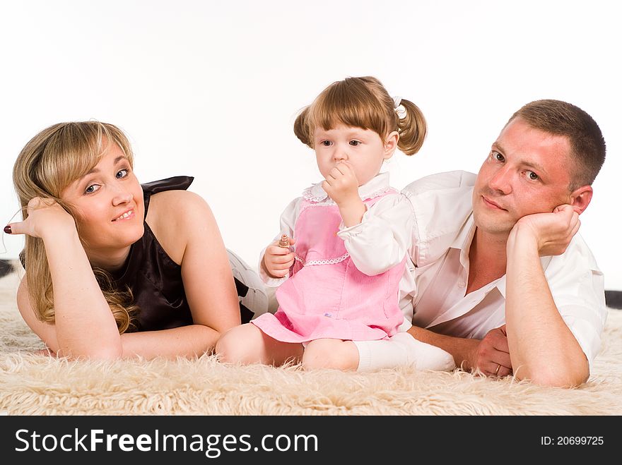 Nice family of a three playing on a carpet. Nice family of a three playing on a carpet