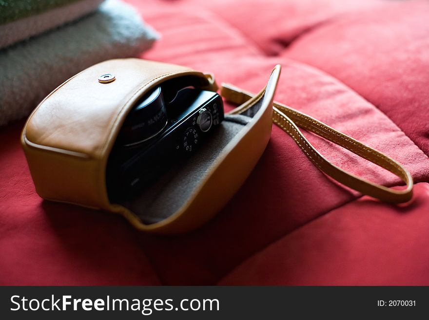 Nice camera on a red sofa.