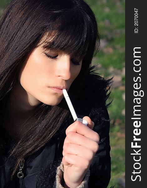 young lady smoke a cigarette. young lady smoke a cigarette