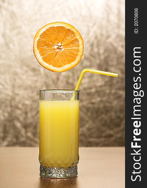 Glass whit fresh juice and orange on top. Glass whit fresh juice and orange on top