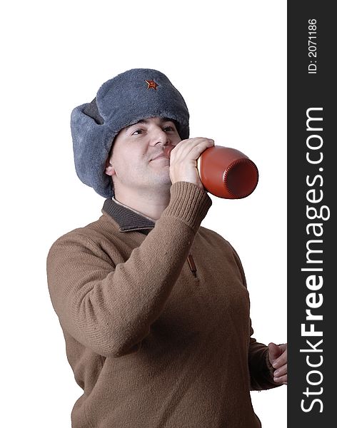 Young casual man portrait with a russian hat and a red bottle