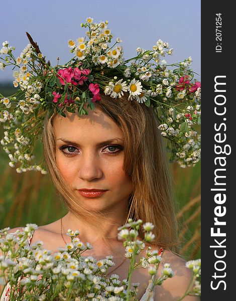 Girl in sunset time with wild flowers. Girl in sunset time with wild flowers