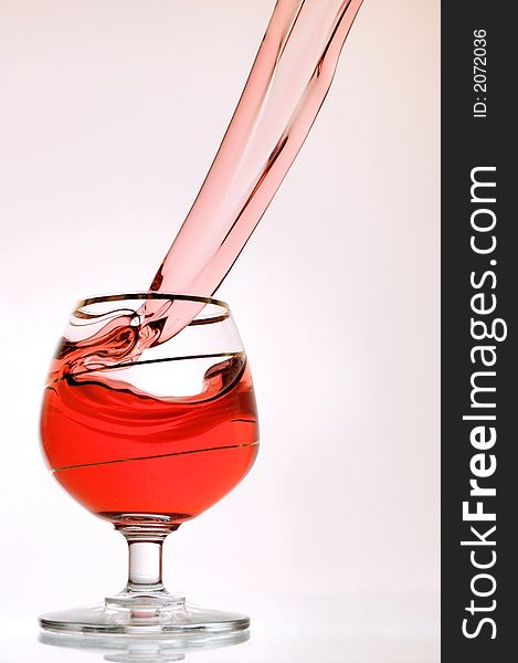 Spilling wine from a glass - high-speed photography. Spilling wine from a glass - high-speed photography.