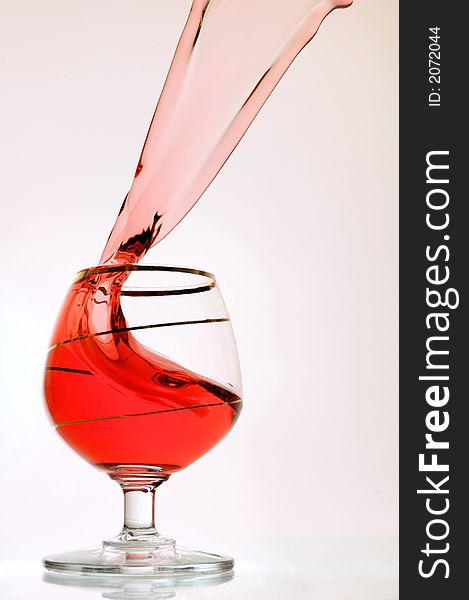 High-speed photography - spilling red wine over white background.