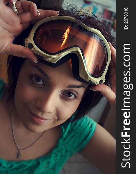 Young brunete girl with big eyes in skiing-glasses