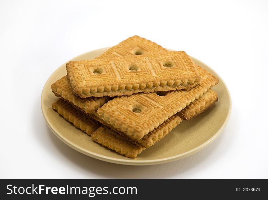 Beautiful cookies in a plate on a white background