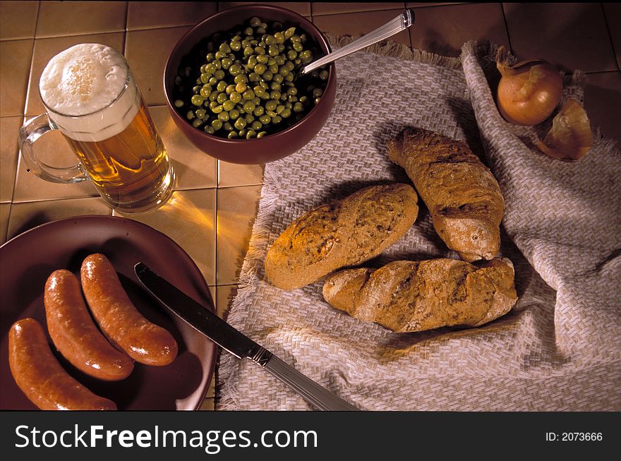 Still-life with a mug of beer, sausages and rolls. Still-life with a mug of beer, sausages and rolls