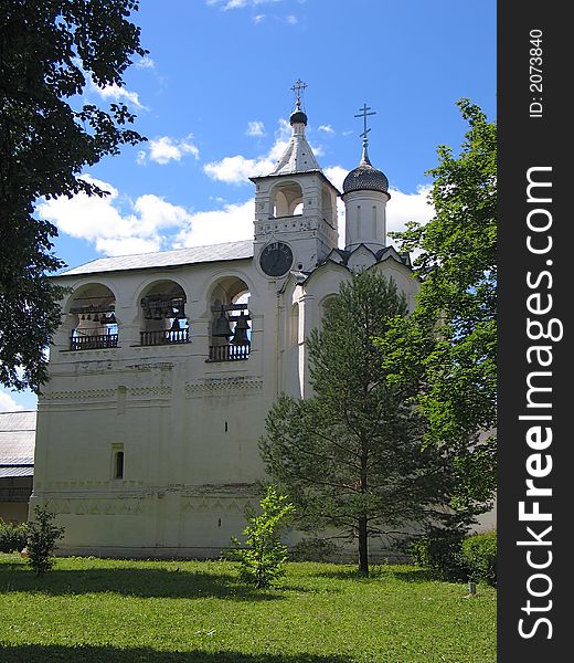 Summer view of Bell-tower with clock in Saviour-Euvfimiev Monastery in Suzdal. (Suzdal, Vladimir region, Golden Ring of Russia). Summer view of Bell-tower with clock in Saviour-Euvfimiev Monastery in Suzdal. (Suzdal, Vladimir region, Golden Ring of Russia)