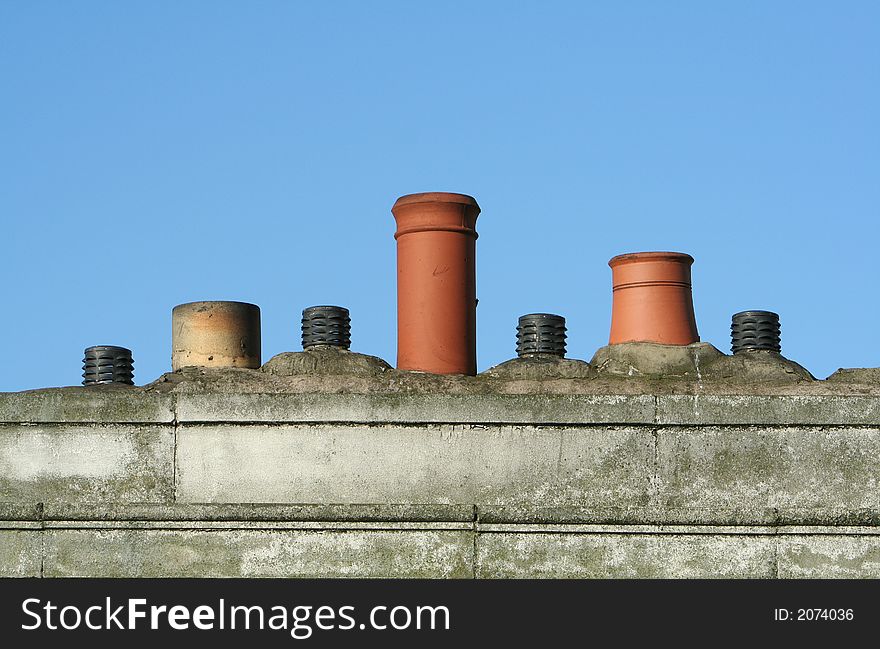 Lining the roof are three chimney pots and four air vents. Lining the roof are three chimney pots and four air vents