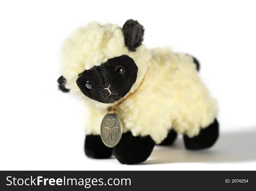 The toy lamb closeup shot on a white background. The toy lamb closeup shot on a white background