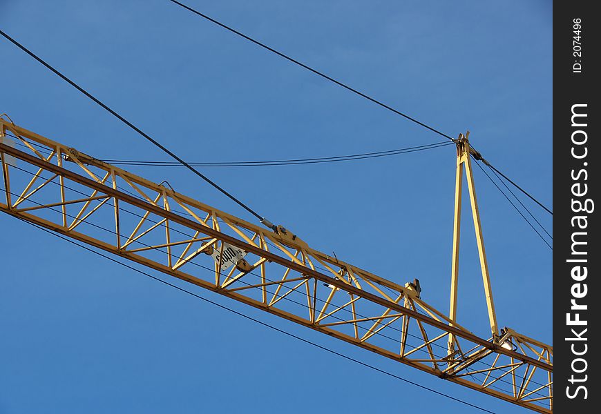 Closeup portrait of yellow crane in blue sky. Closeup portrait of yellow crane in blue sky