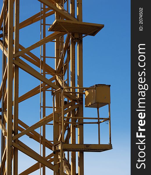 Closeup portrait of yellow crane in blue sky. Closeup portrait of yellow crane in blue sky