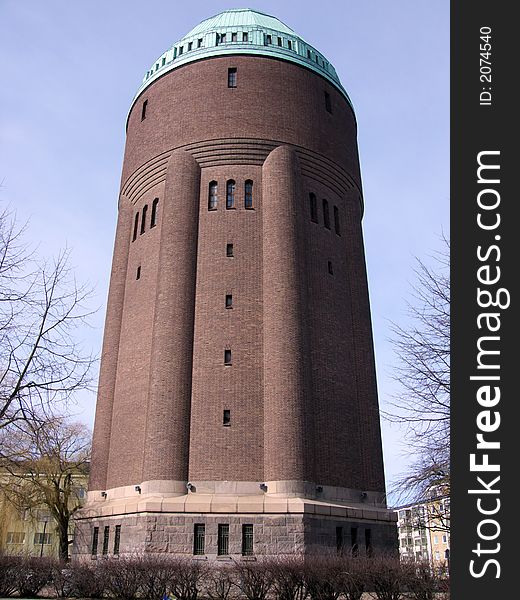 Portrait of huge water tower in blue sky