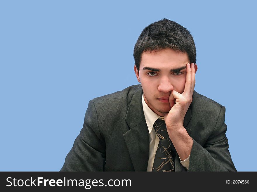 Young Businessman thinking,isolated on blue