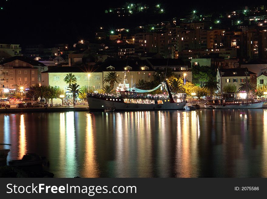 Coast line with a lit ship. Coast line with a lit ship.