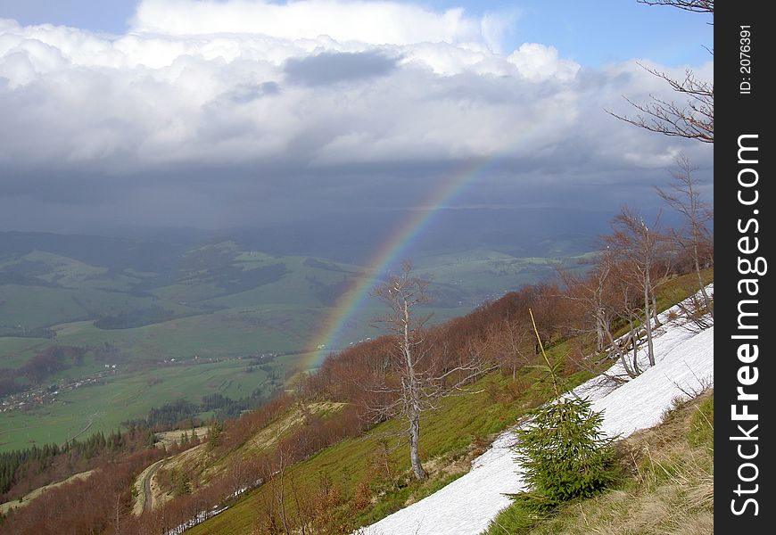 Rainbow on height of bird flight in the mountains of Carpathians. Rainbow on height of bird flight in the mountains of Carpathians