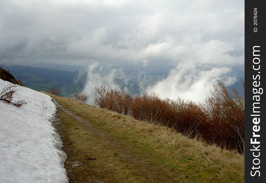 Clouds pass a road in mountains. Clouds pass a road in mountains