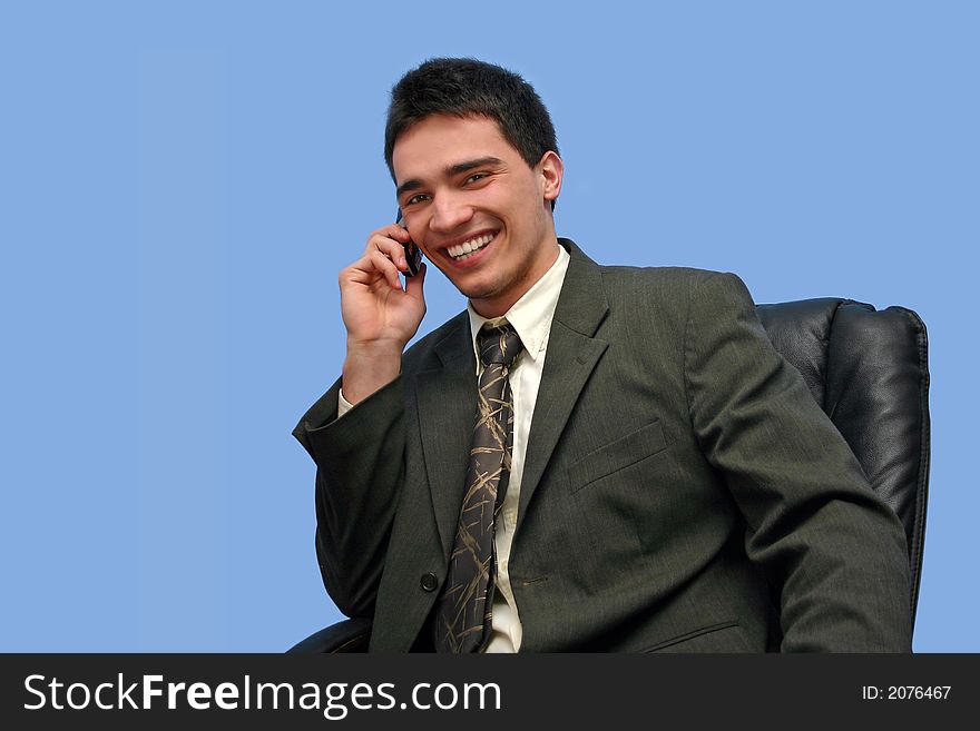 Young Businessman talking on the phone,isolated on blue