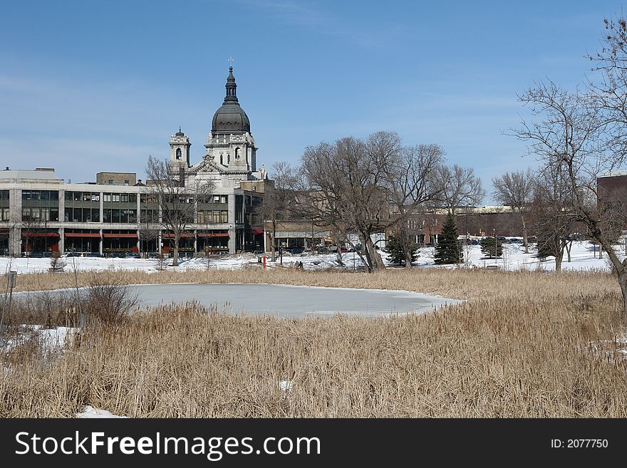 A picture of buildings on the other side of a frozen pond. A picture of buildings on the other side of a frozen pond.