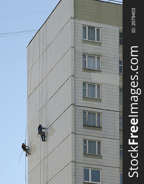 Two men concern with repair of the building