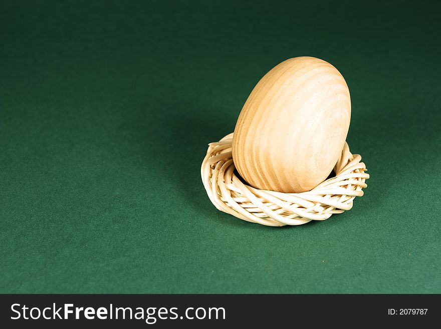 Photo of a wooden egg on green. Photo of a wooden egg on green