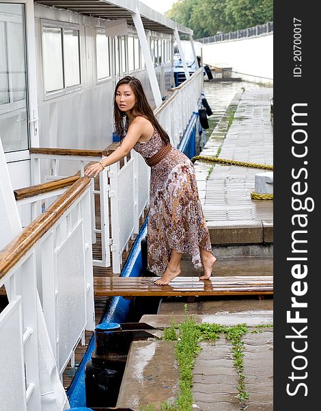 Beautiful girl walking near river in summer