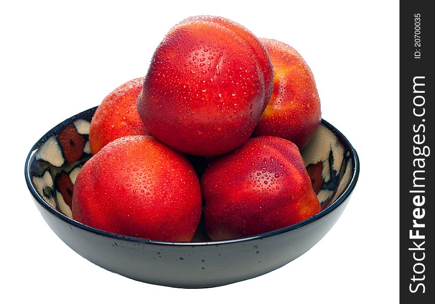 A bowl full of nectarines. The nectarines are fresh, wet, vibrant and juicy. A bowl full of nectarines. The nectarines are fresh, wet, vibrant and juicy.