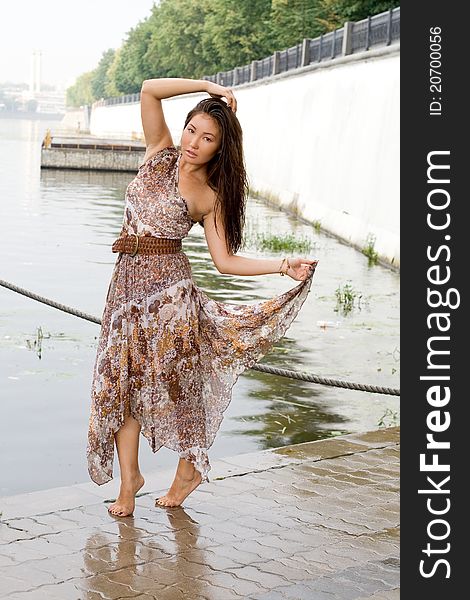 Beautiful girl walking near river