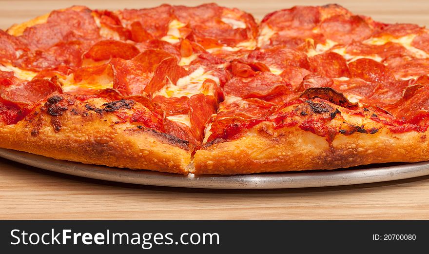 A very tempting image of a delicious pepperoni pizza. This image is a closeup to add uniqueness to the photograph.