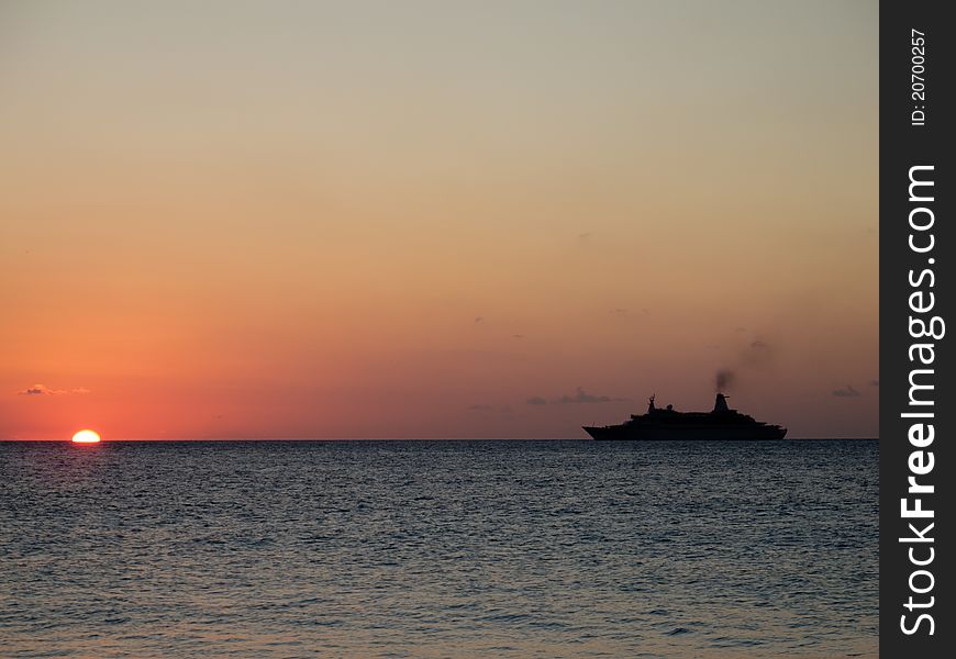 Silhouette of a cruiseship sailing into the setting sun. Silhouette of a cruiseship sailing into the setting sun