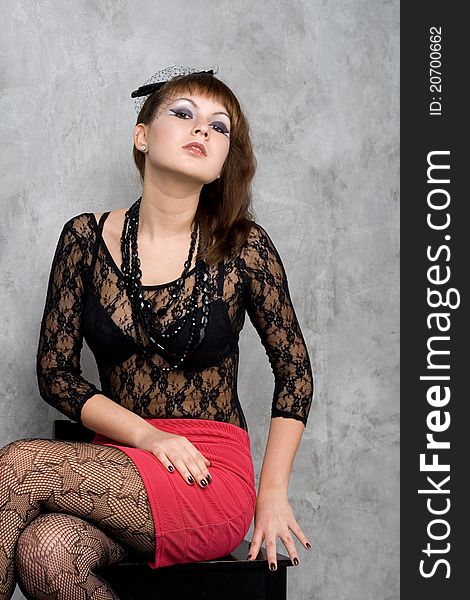 Cute gothic girl sitting on chair studio shot