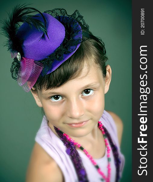 The small woman of fashion in a beautiful hat and with a beads