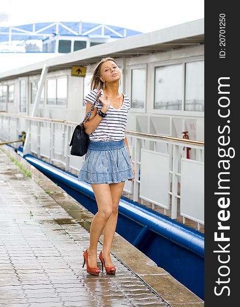 Girl walking on embankment in summer