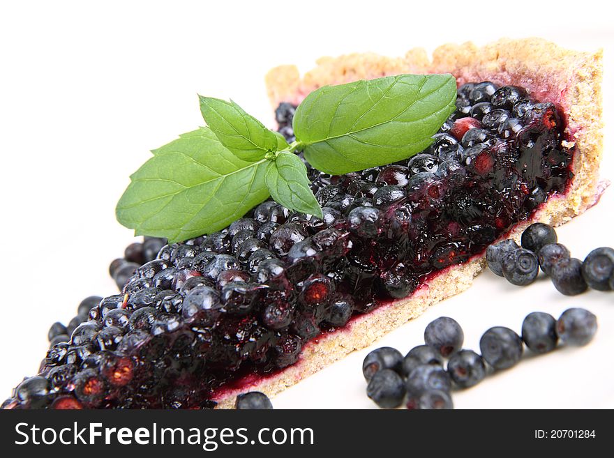 Blueberry Tart: a portion on a plate decorated with mint