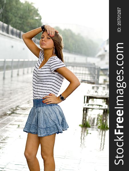 Girl walking outdoor on embankment under rain. Girl walking outdoor on embankment under rain