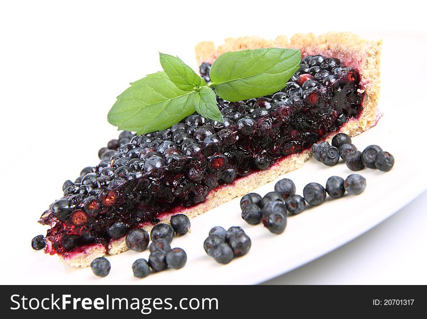 Blueberry Tart: a portion on a plate decorated with mint