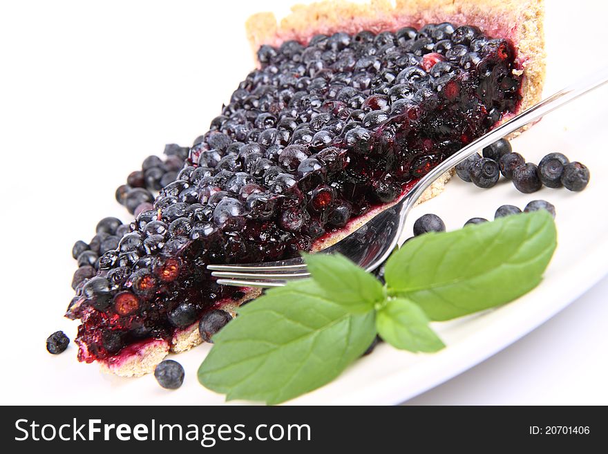 Blueberry Tart: a portion on a plate decorated with mint