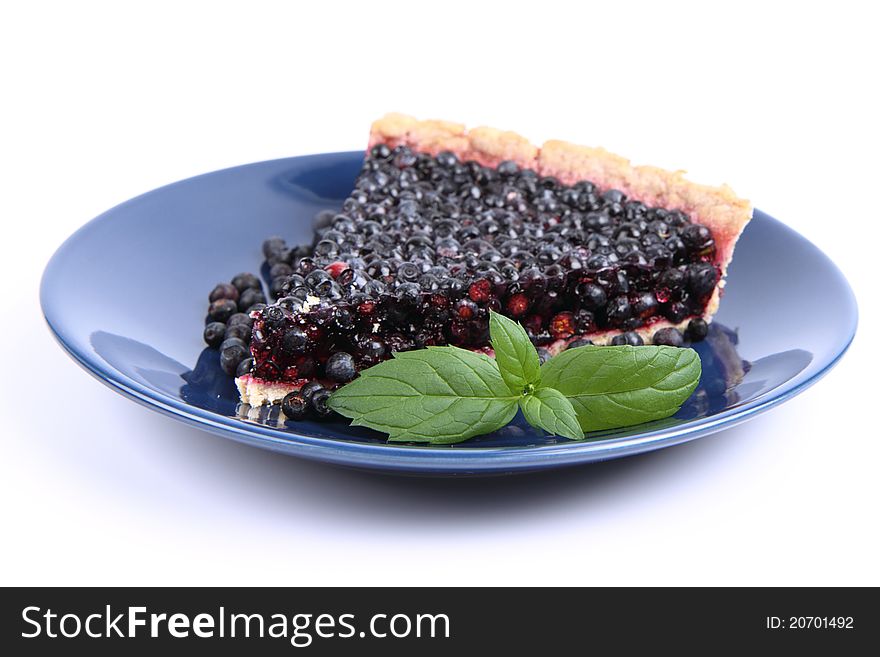 Blueberry Tart: a portion on a plate decorated with mint